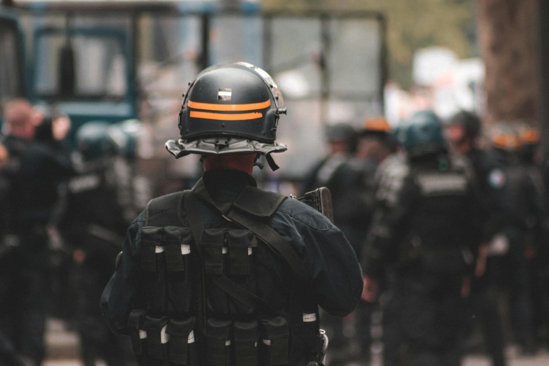 Tactical officer facing a group of fellow officers